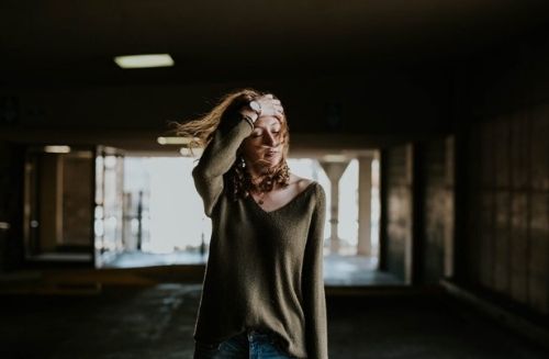 woman standing with hair blowing in air